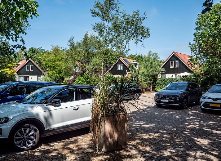 Cozy living room of Koetshuis vacation home in De Koog, Texel, with comfortable sofas and warm decor on the Wadden Islands.