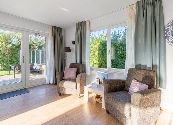 Gemuetliche Terrasse des Ferienhauses Kamperfoelie 97, De Koog, Texel, umgeben von viel Gruen auf den schoenen Watteninseln.