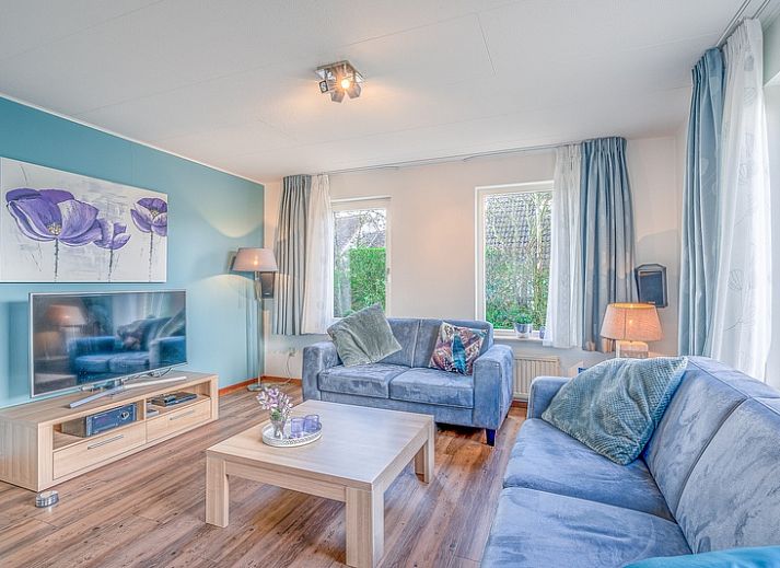 Vacation home Honeysuckle 55 in De Koog Texel overlooking green garden and water feature.