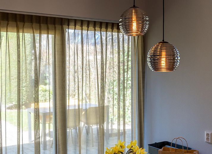 Cozy terrace at Zilte Bries vacation home, De Koog, Texel, overlooking green garden.