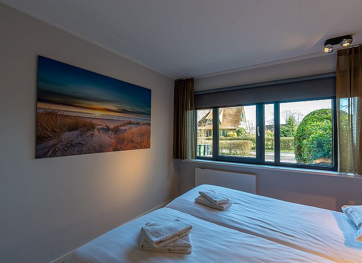 Modern living room of Zilte Bries vacation home, De Koog, Texel, with comfortable seating area.