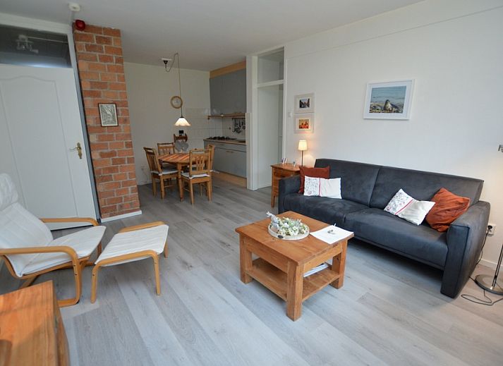 Cozy living room of Apartment Kerckeland 20 in De Koog, Texel with comfortable sitting area and dining area.