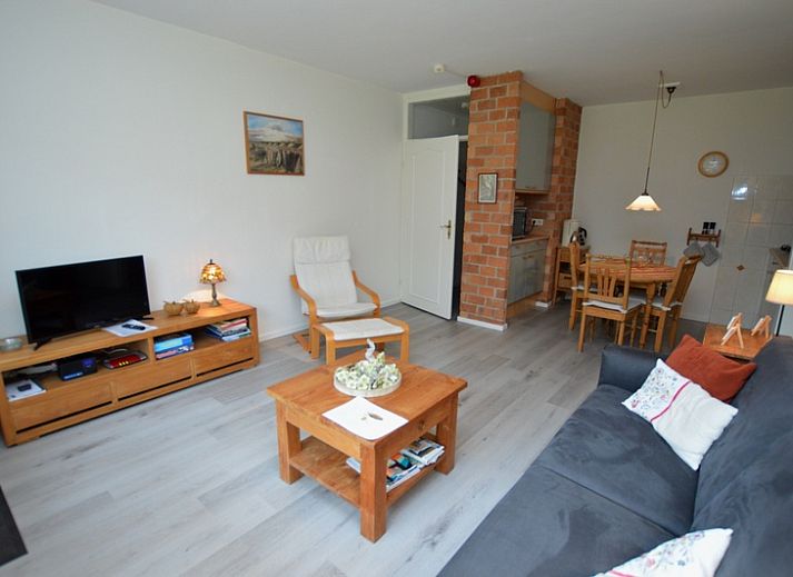 Bright living room of Apartment Kerckeland 20 in De Koog, Texel overlooking the green surroundings.