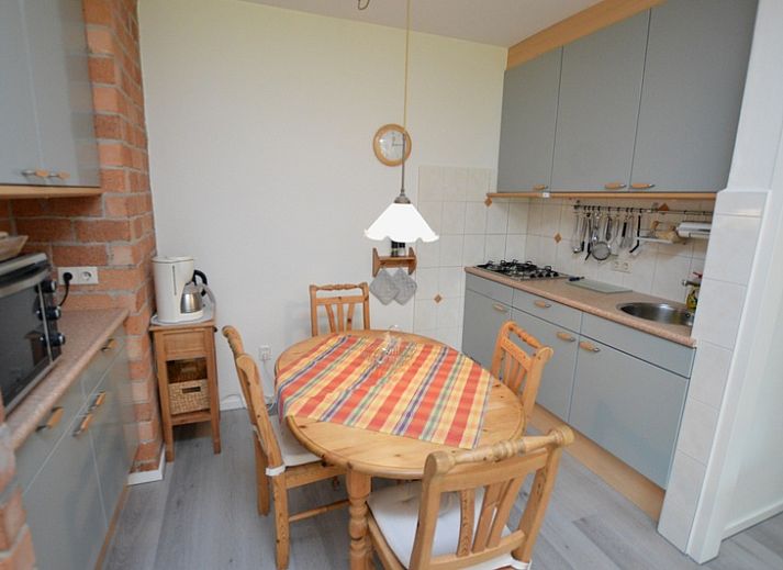 Bright living room of Apartment Kerckeland 20 in De Koog, Texel overlooking the green surroundings.