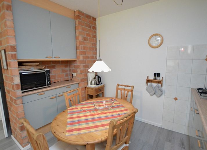 Bright living room of Apartment Kerckeland 20 in De Koog, Texel overlooking the green surroundings.