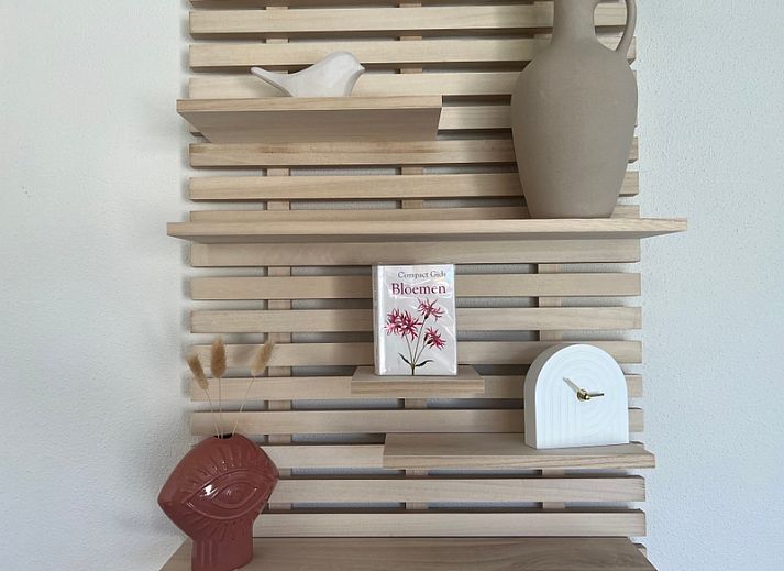 Cozy living room of De Duinroos in De Koog, Texel with comfortable sofas and lots of light.