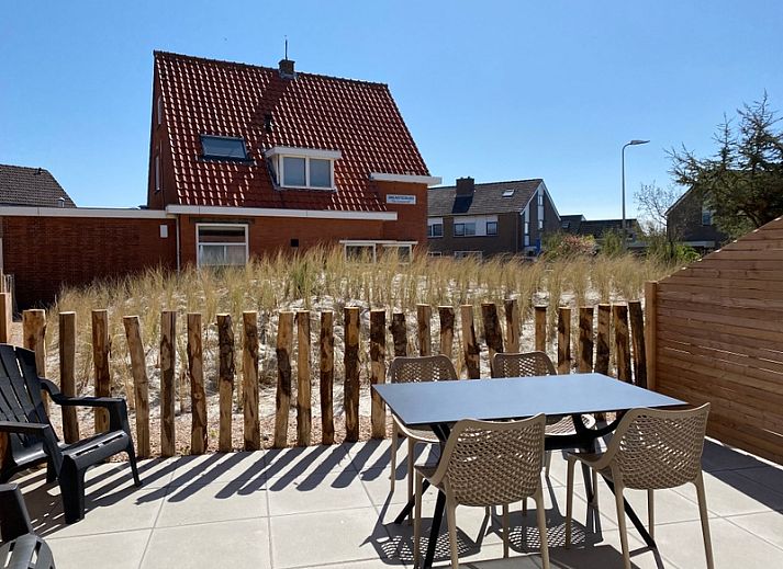 Cozy living room of De Duinroos in De Koog, Texel with comfortable sofas and lots of light.