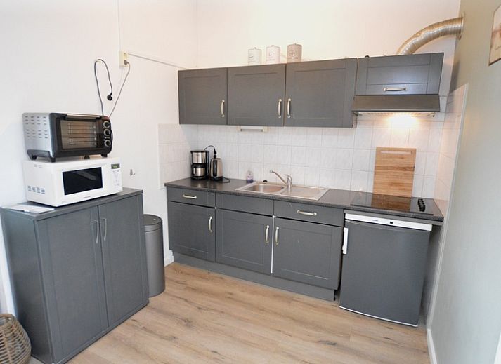 Spacious kitchen and dining area in Motel Texel - Apartment 314/1S, De Koog, with modern amenities.