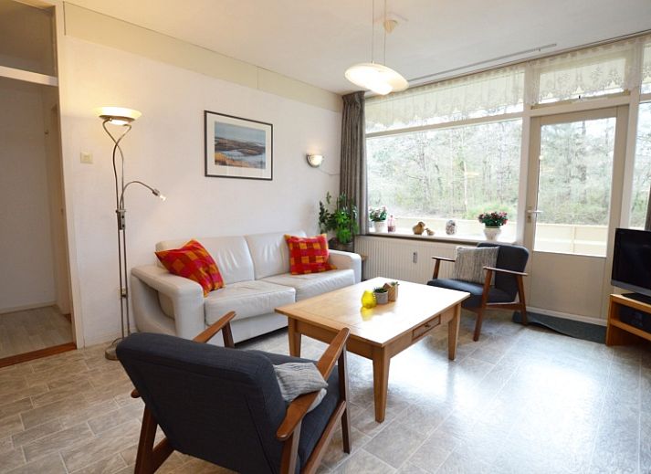 Cozy living room of Apartment Kerckeland 16 in De Koog, Texel with comfortable sitting area and dining area.