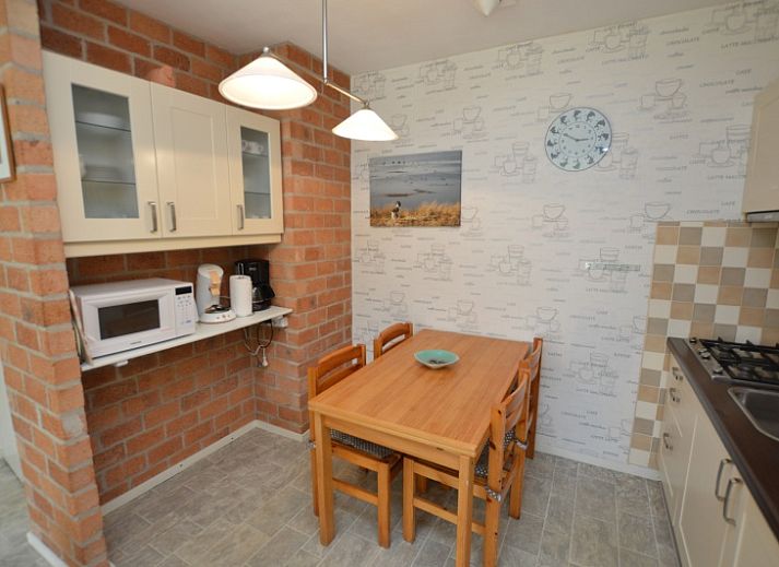 Cozy living room of Apartment Kerckeland 16 in De Koog, Texel with comfortable sitting area and dining area.