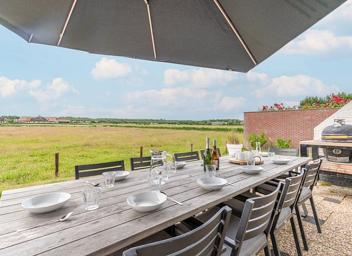 Dining area in Cottage in De Koog, Texel, overlooking green fields, Wadden Islands.