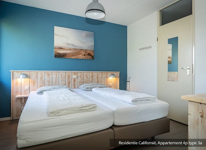 Cozy living room of Type 3A vacation home in De Koog, Texel with comfortable sitting area and dining area.