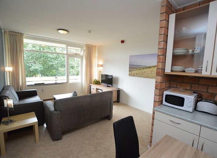 Cozy living room in Apartment Kerckeland 122, De Koog, Texel overlooking greenery.