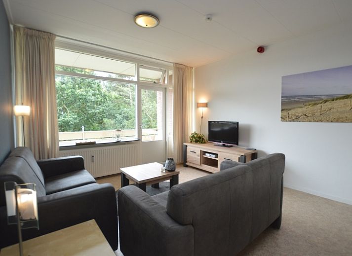 Cozy living room in Apartment Kerckeland 122, De Koog, Texel overlooking greenery.