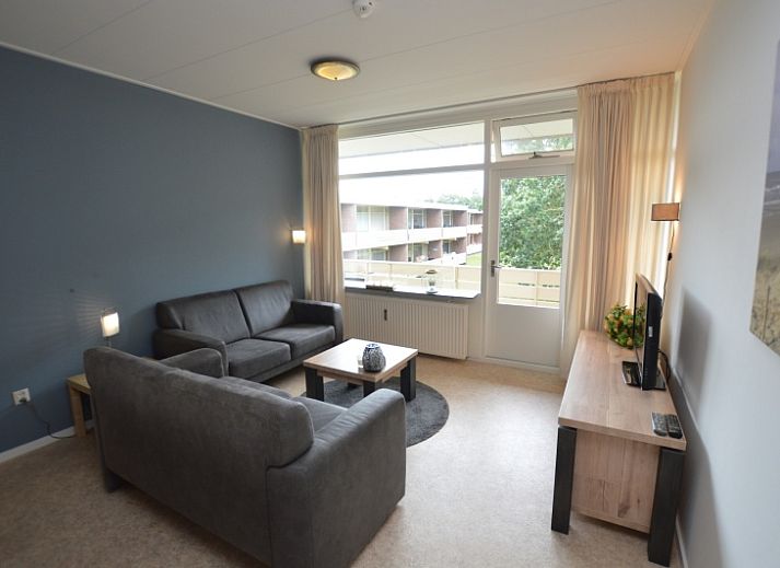 Cozy living room in Apartment Kerckeland 122, De Koog, Texel overlooking greenery.