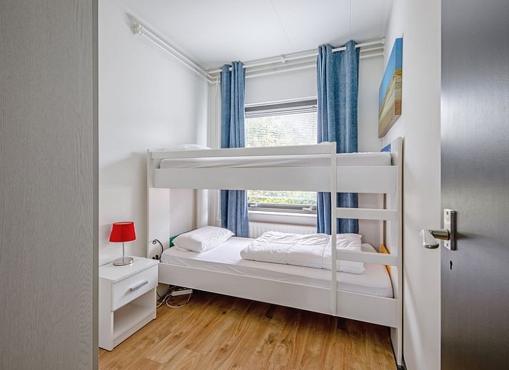 Cozy living room with fireplace in Orchismient 55 vacation home De Koog Texel.