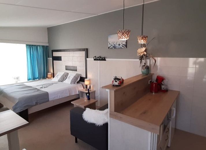 Attractive bedroom in Apartment Duinzee Texel, De Koog, with comfortable double bed and cozy sitting area.
