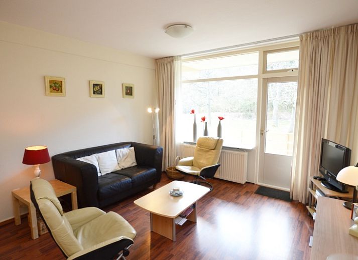 Cozy living room in Apartment Kerckeland 24, De Koog, Texel with modern furnishings and comfortable seating area.