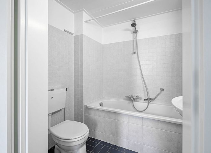 Spacious sitting area in Two persons apartment large - first floor, De Koog, Texel with comfortable sofa and armchair.