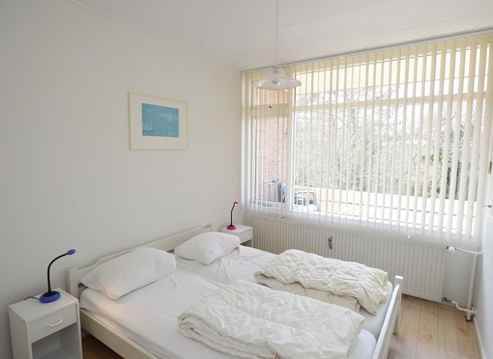 Bright living room with large windows in Apartment Kerckeland 80, De Koog, Texel, ideal for relaxation.