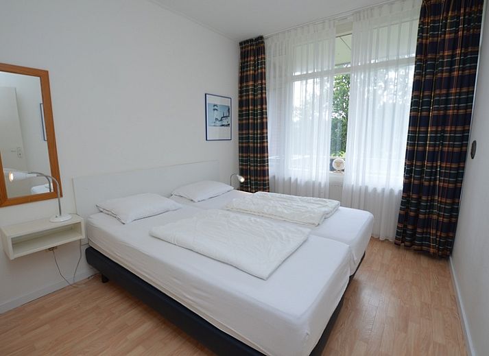 Spacious interior of Apartment Kerckeland 126 in De Koog, Texel, with dining area and view of the greenery.