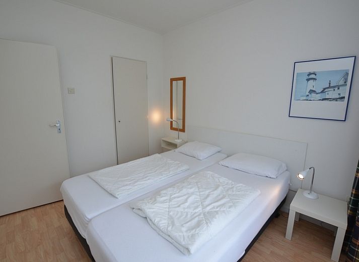 Spacious interior of Apartment Kerckeland 126 in De Koog, Texel, with dining area and view of the greenery.