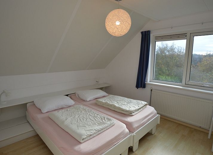Bright sitting area in Holiday home Stappeland 199, De Koog, Texel, with modern furniture and a cozy wood stove.