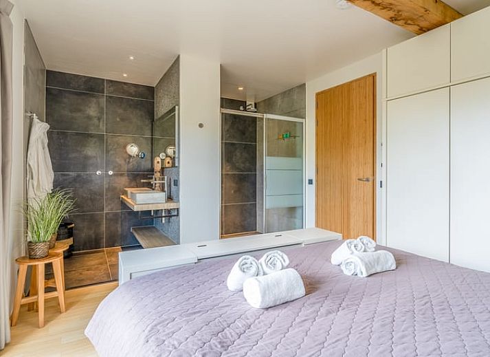 Modern kitchen and dining area in Holiday home in De Koog, Texel, with wooden beams.