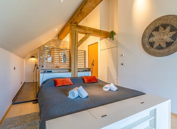 Modern kitchen and dining area in Holiday home in De Koog, Texel, with wooden beams.