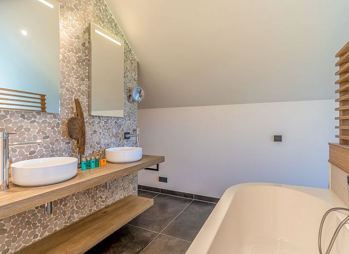 Wooden fireplace in cottage in De Koog overlooking terrace and nature.