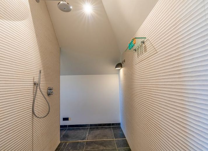 Wooden fireplace in cottage in De Koog overlooking terrace and nature.