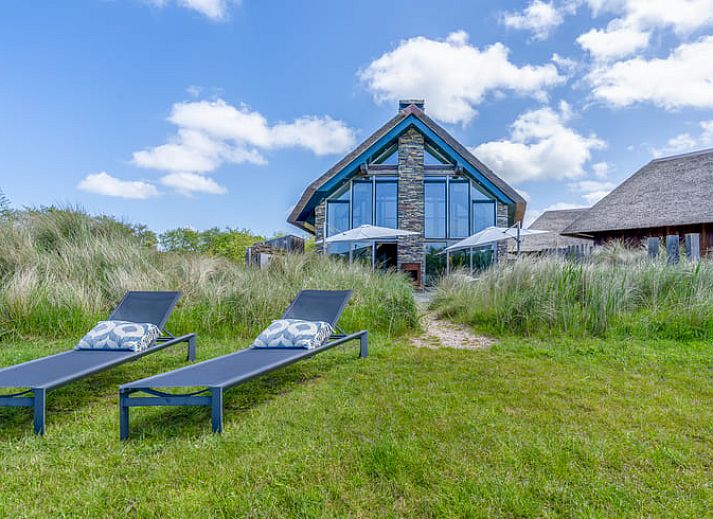 Sitting area with colorful cushions in Holiday cottage in De Koog, Texel, Wadden Islands.