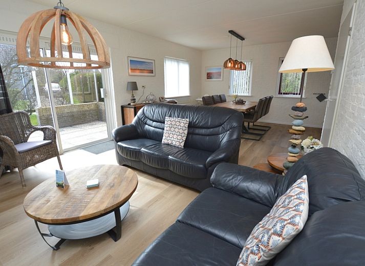 Cozy living room in Holiday home Stappeland 205, De Koog, Texel with comfortable seating area and access to the garden.