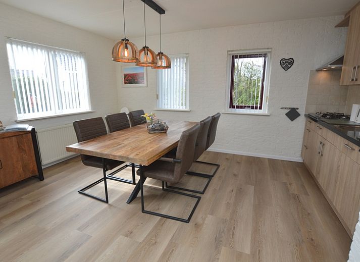 Cozy living room in Holiday home Stappeland 205, De Koog, Texel with comfortable seating area and access to the garden.