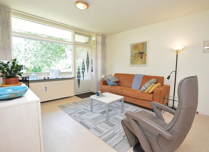 Gemuetliches Wohnzimmer im Appartement Kerckeland 64, De Koog, Texel mit bequemer Sitzecke und viel Licht.