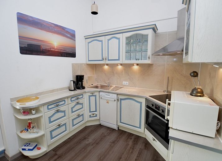 Spacious indoor area of Motel Texel - Apartment 315/1T, De Koog, Texel with dining area and terrace view.