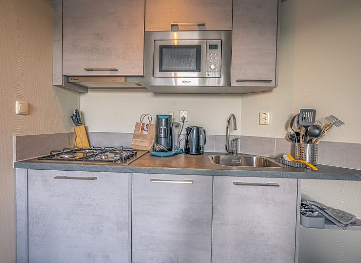 Bright living room with comfortable sofa in Apartment Zeedistel 24, De Koog, Texel.