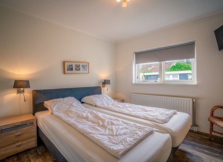 Spacious living room of Orchismient 2, vacation home in De Koog, Texel with comfortable sofa and dining area.