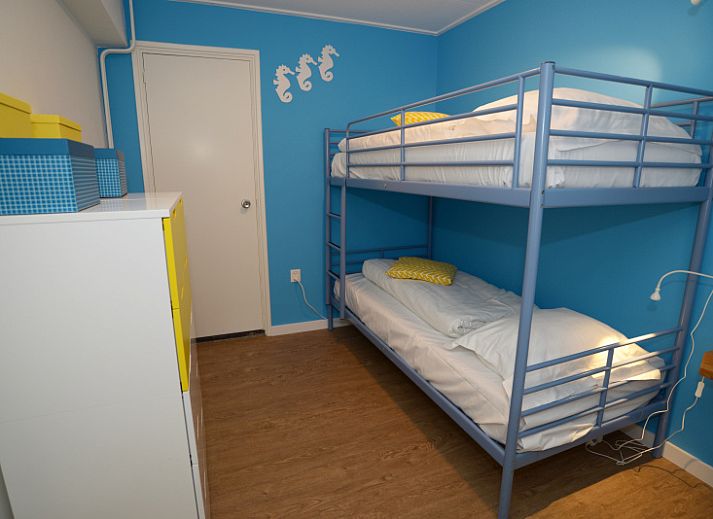 Exterior of Grand Hotel Opduin - Apartment C in De Koog, Texel, with charming architecture and cycling guests.