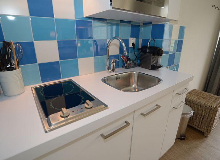 Exterior of Grand Hotel Opduin - Apartment C in De Koog, Texel, with charming architecture and cycling guests.