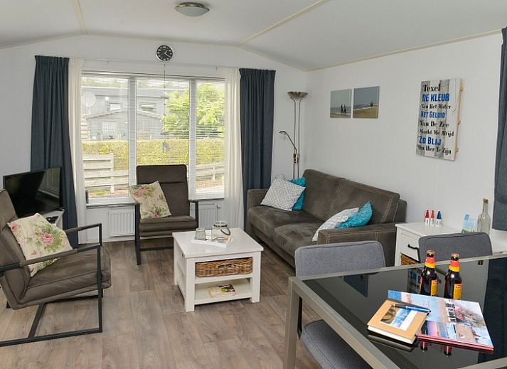 Spacious terrace with green fence at Chaletpark Bregkoog - Chalet Bregkoog 138 'Sinne', ideal for relaxation in De Koog, Texel.