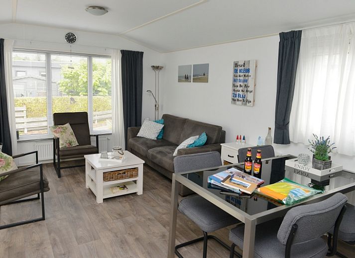 Spacious terrace with green fence at Chaletpark Bregkoog - Chalet Bregkoog 138 'Sinne', ideal for relaxation in De Koog, Texel.