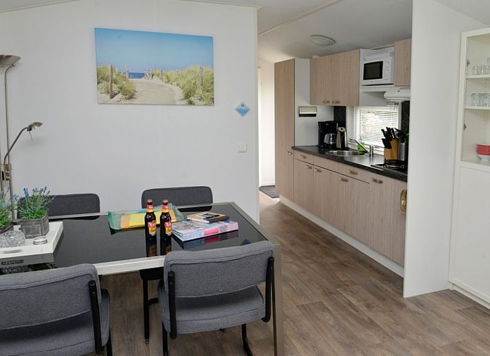 Spacious terrace with green fence at Chaletpark Bregkoog - Chalet Bregkoog 138 'Sinne', ideal for relaxation in De Koog, Texel.