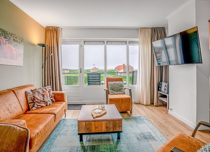 Cozy living room in Apartment Juliana 136 Island and Sea View, De Koog, Texel with a view of nature.
