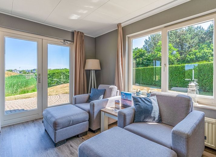 View of Holiday home Honeysuckle 71 in De Koog, Texel with green surroundings.