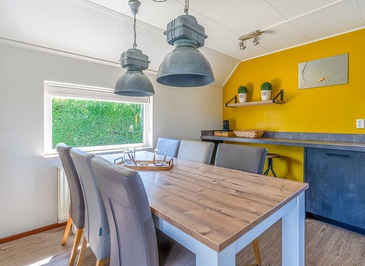 View of Holiday home Honeysuckle 71 in De Koog, Texel with green surroundings.