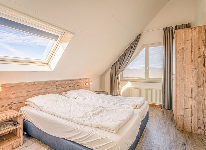 View of Holiday home Honeysuckle 71 in De Koog, Texel with green surroundings.