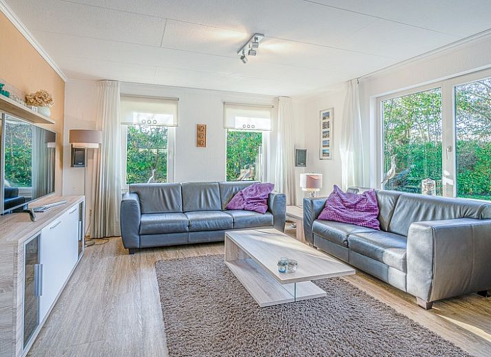 Vacation home Honeysuckle 59 in De Koog Texel, surrounded by lush nature and a serene pond.