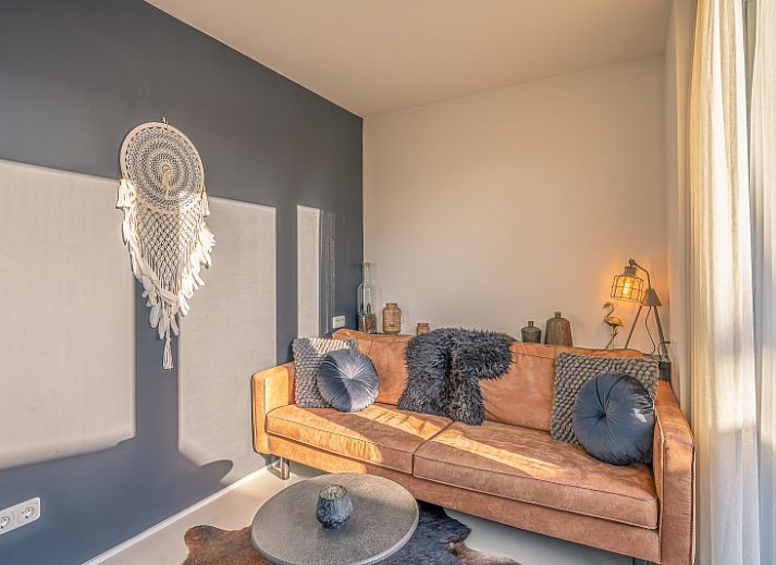 Enjoy the sunny veranda at Het Bospad - Brink 15 in De Koog, Texel. Perfect for relaxation on the Wadden Islands.