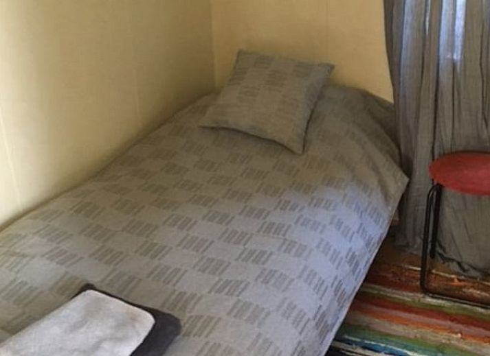 Vacation cottage in De Koog with inviting veranda and flowering garden, Texel, Wadden Islands.